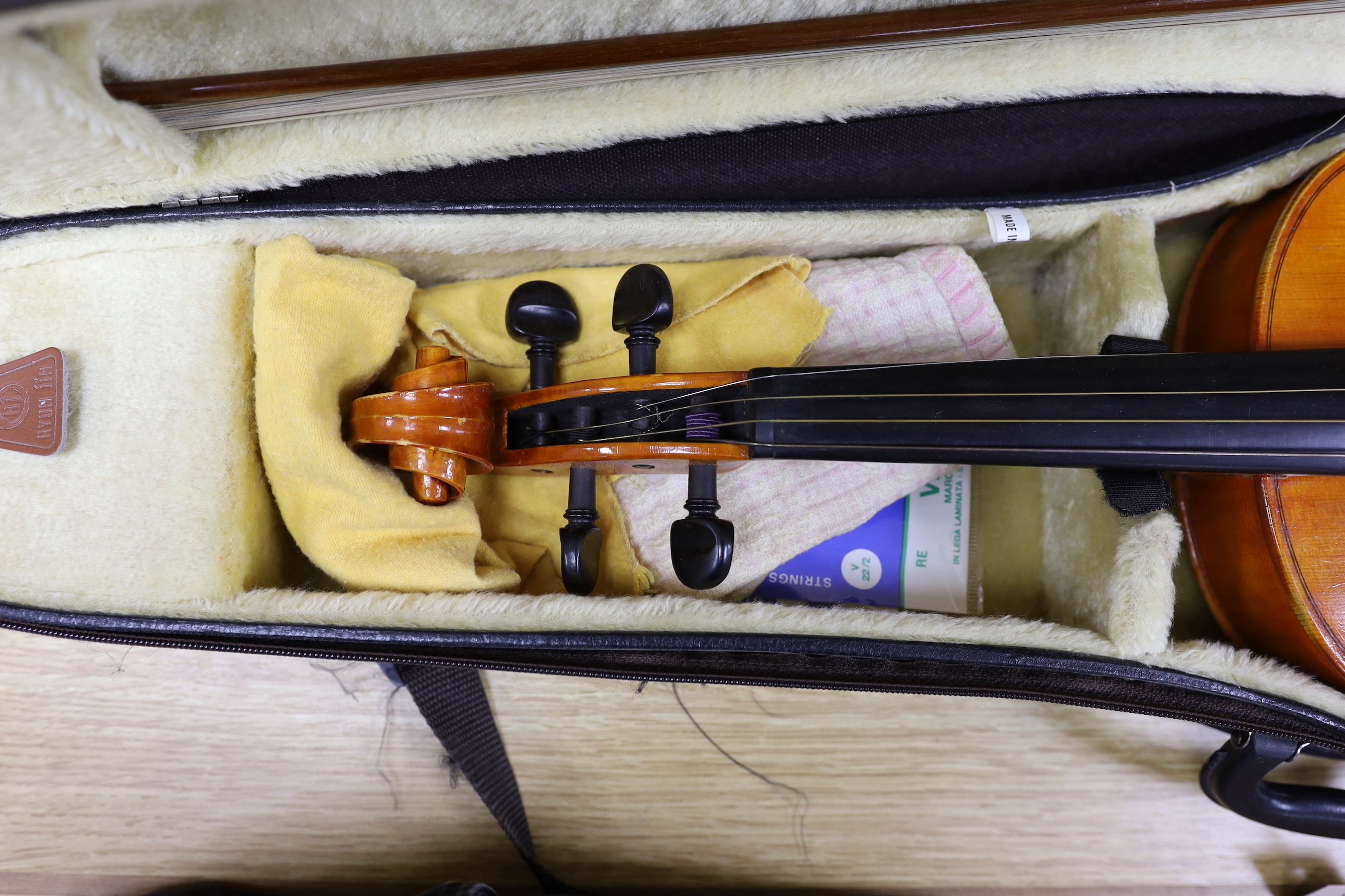 A cased viola crackled glaze, with bow